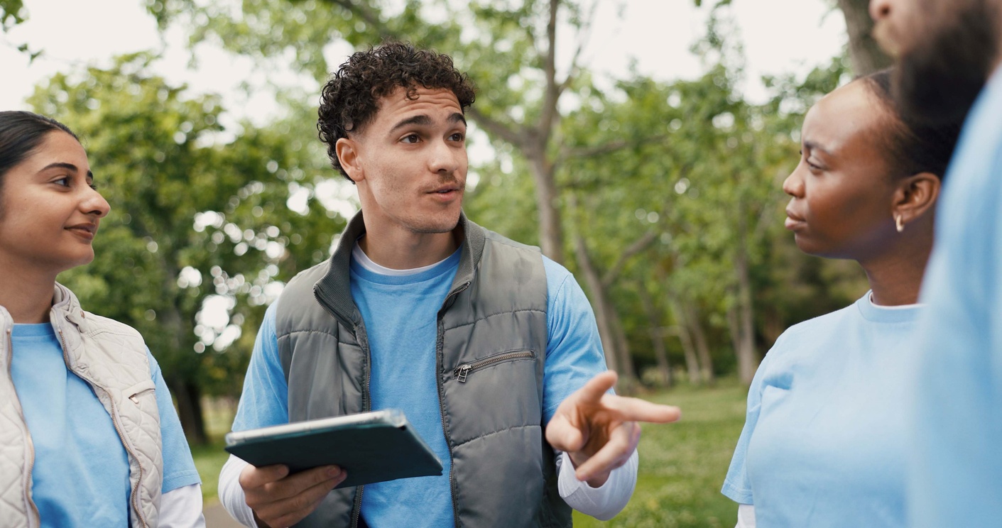 A person with ipad talking to others