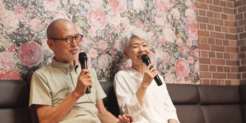 two elderly people singing